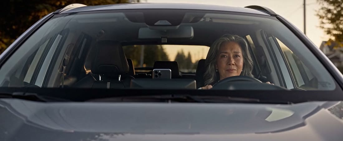 Dusk through the windshield. The phone UI on the dash is ours.
