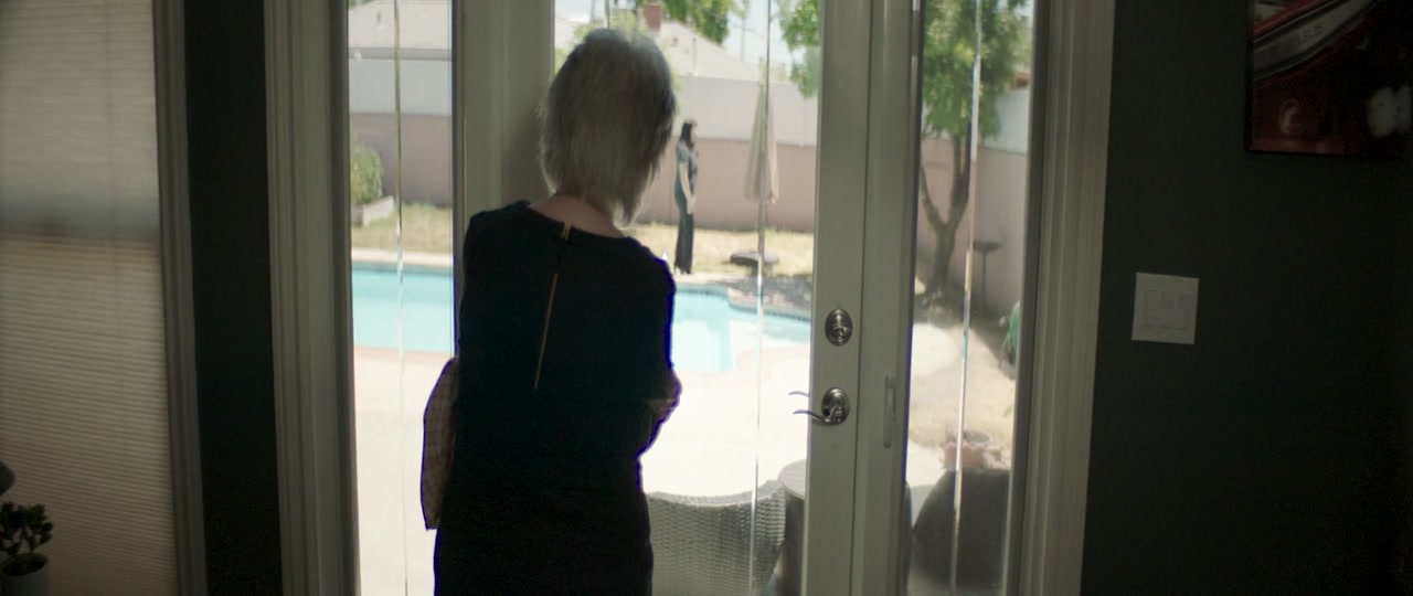 A figure watching another through french doors, from Laughing Again
